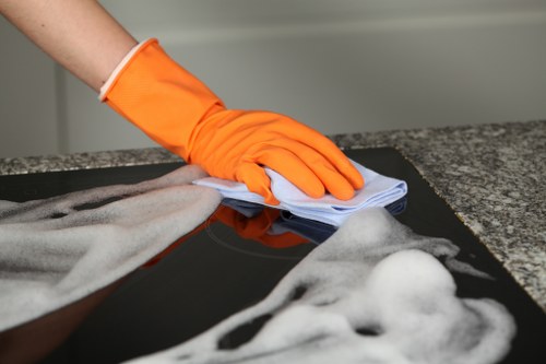 Close-up of an oven cleaner in Ilford polishing oven glass and removing grime